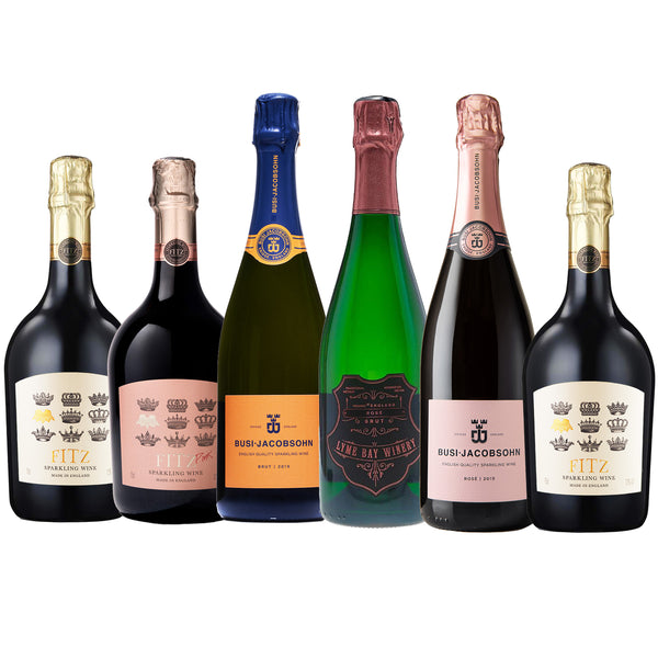 Collection of six English sparkling wine bottles from three different brands on a white background
